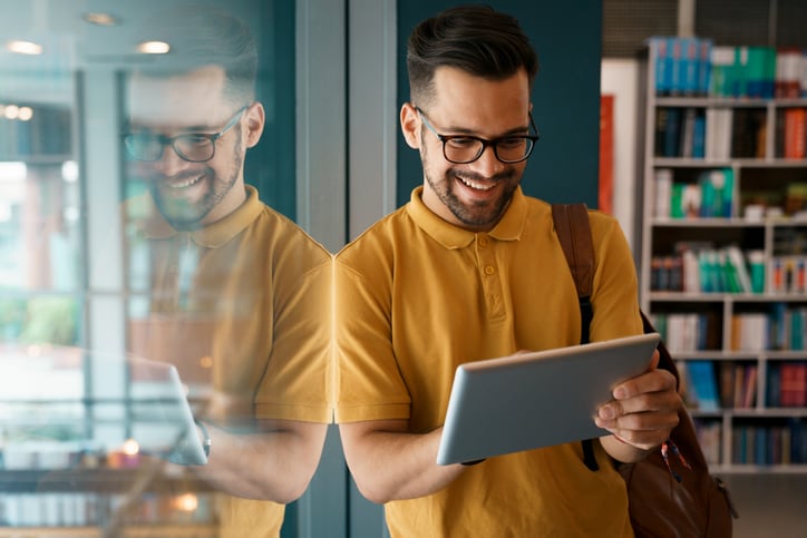 Man in office smiling tablet