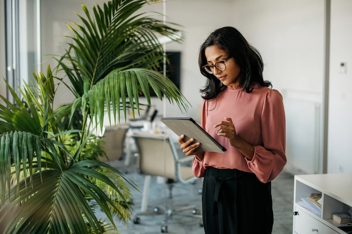 Woman looking at the mumbers on tablet