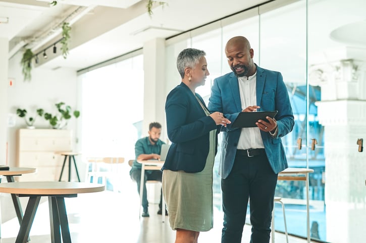 Two Finance People checking Solutions on tablet