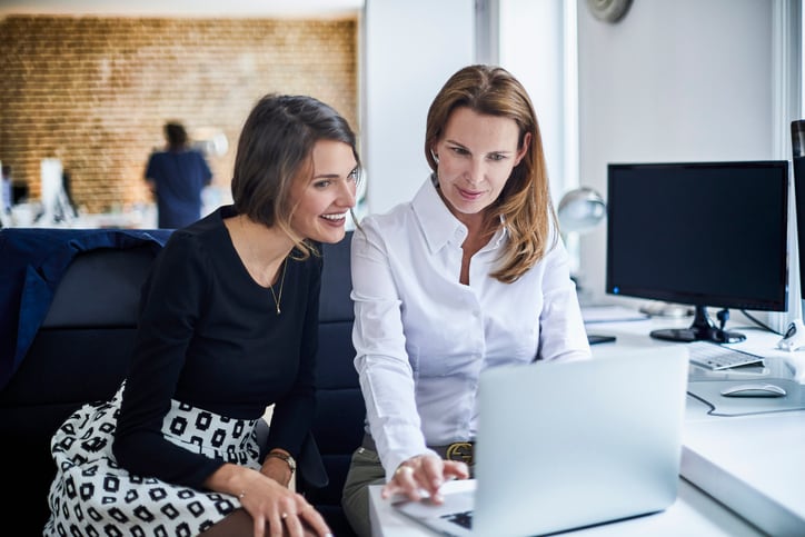 Women in the office looking on screen